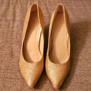 Gold high heels, red bottom
